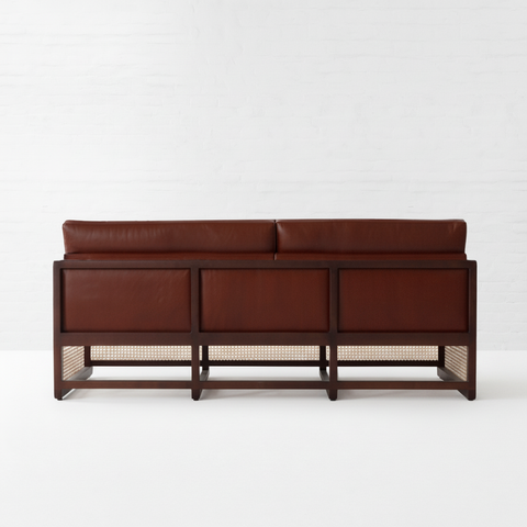 The Veda rattan leather sofa back view pure white background with shadow